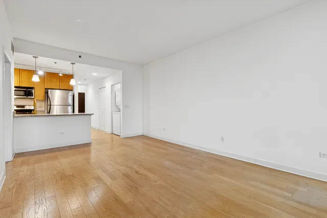 a view of a kitchen with wooden floor and a sink