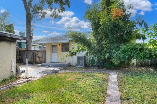 a view of a backyard with a tree