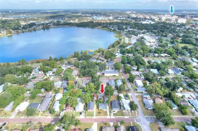 an aerial view of residential houses with outdoor space and lake view
