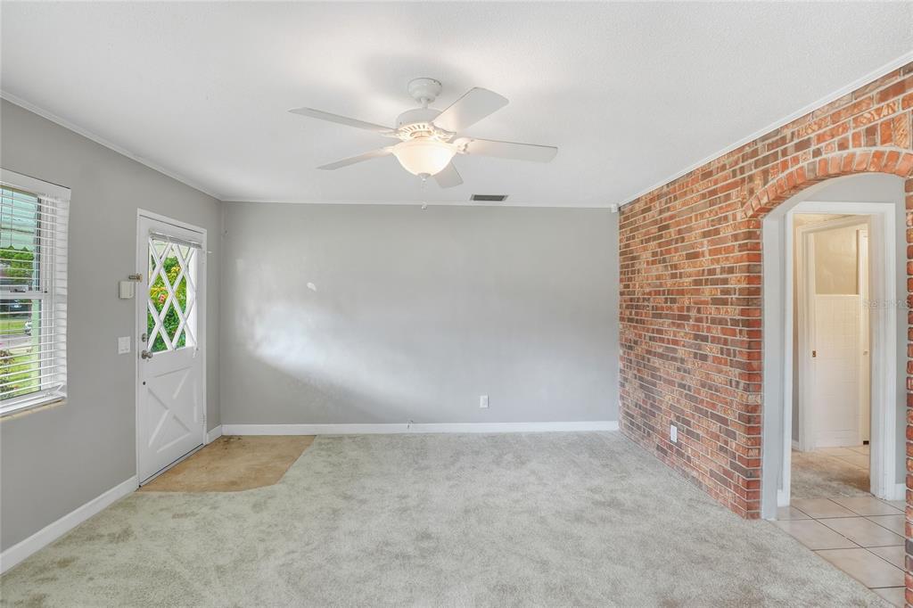 609 West Park Street Lakeland, FL 33803 - Photo 6 of 30 an empty room with windows and chandelier fan