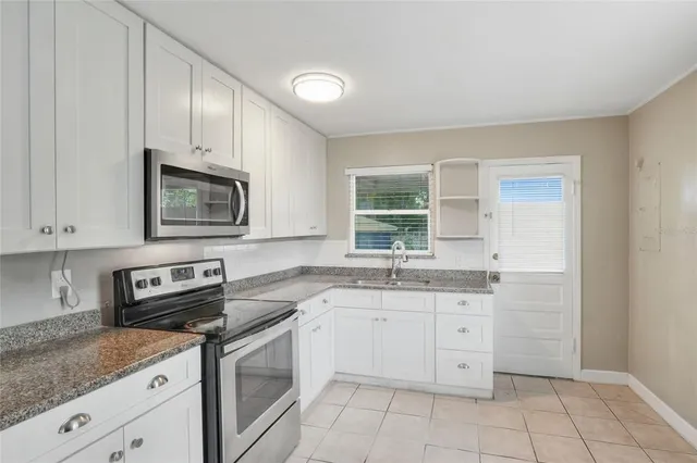 a kitchen with a sink stove and microwave