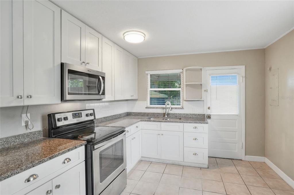 609 West Park Street Lakeland, FL 33803 - Photo 8 of 30 a kitchen with a sink stove and microwave