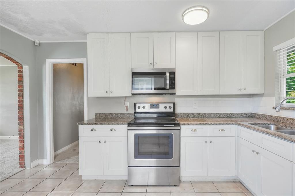 609 West Park Street Lakeland, FL 33803 - Photo 10 of 30 a kitchen with white cabinets stainless steel appliances and sink