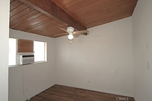 a view of a hallway with a chandelier fan and wooden floor