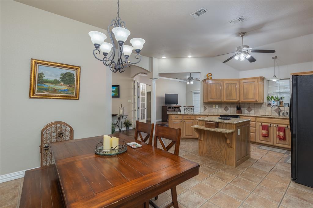 257 Reatta Drive Decatur, TX 76234 - Photo 18 of 39 a view of a dining room with furniture a chandelier and wooden floor