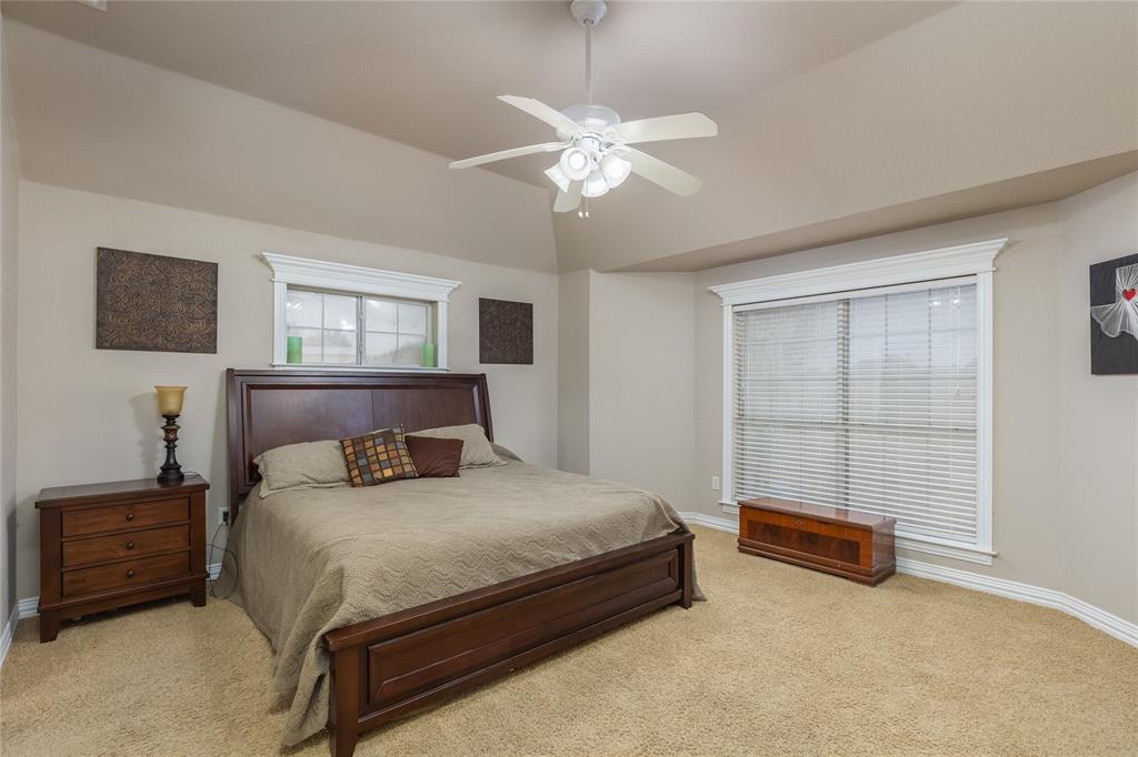 257 Reatta Drive Decatur, TX 76234 - Photo 20 of 39 a bedroom with a bed and a night stand