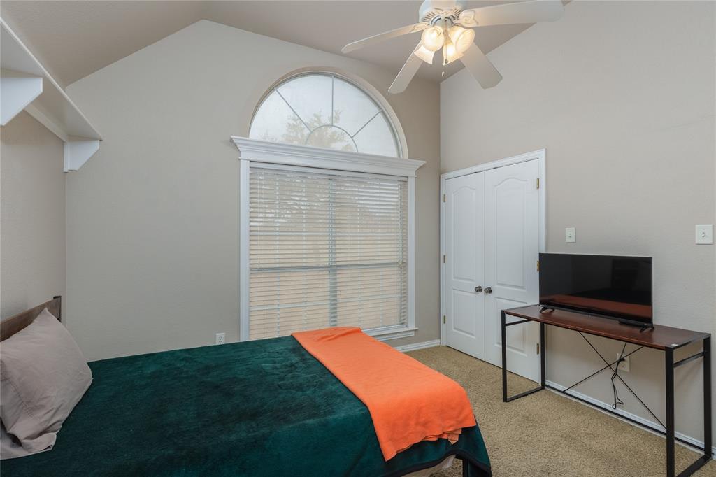 257 Reatta Drive Decatur, TX 76234 - Photo 26 of 39 a bedroom with a bed and a chandelier