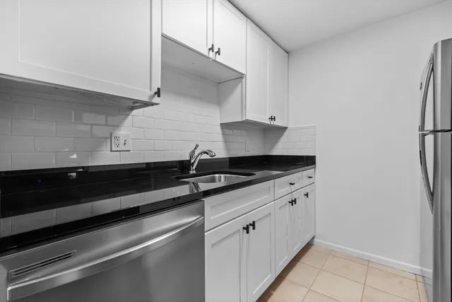 a close view of a sink and a stove in a kitchen
