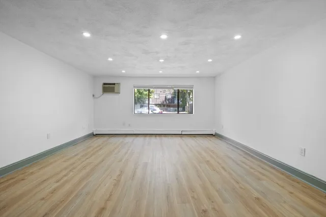 a view of an empty room and a window