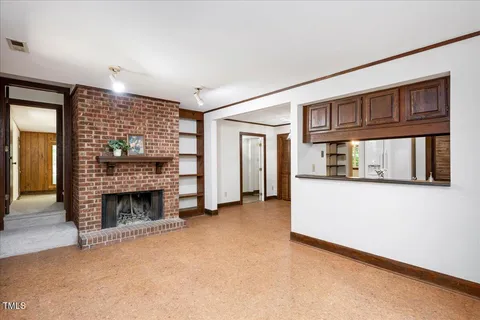 a view of empty room with fireplace and cabinet