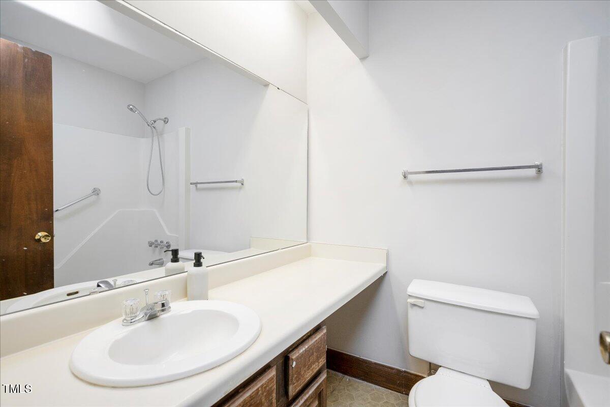 11637 Appaloosa Run West Raleigh, NC 27613 - Photo 22 of 29 a bathroom with a sink a toilet a mirror and shower
