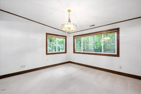 an empty room with windows and outdoor view