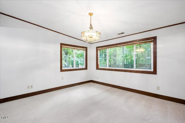 an empty room with windows and outdoor view