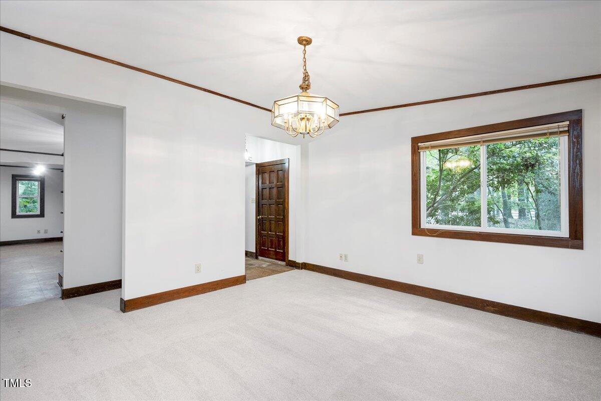 11637 Appaloosa Run West Raleigh, NC 27613 - Photo 5 of 29 an empty room with chandelier fan and windows