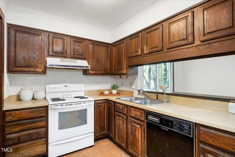a kitchen with stainless steel appliances granite countertop a sink stove and cabinets