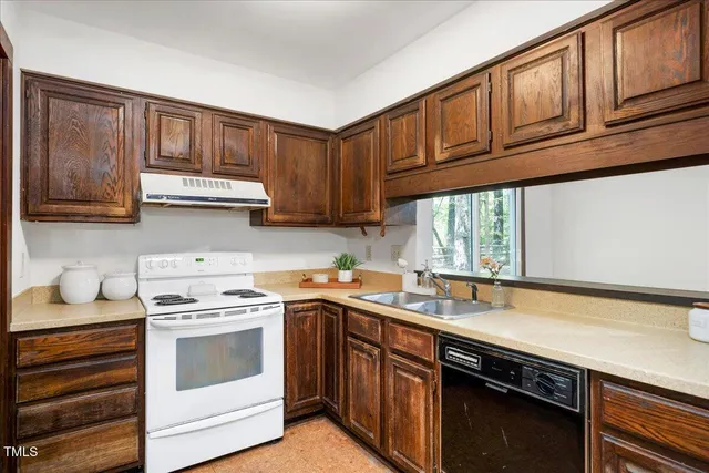 a kitchen with stainless steel appliances granite countertop a sink stove and cabinets