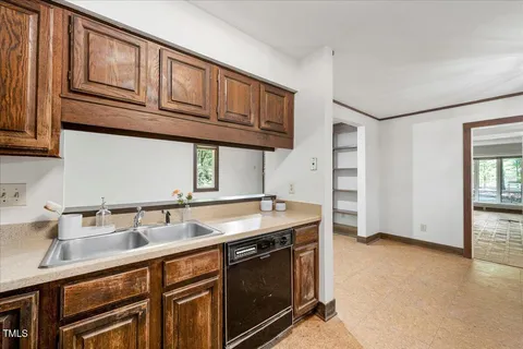 a kitchen with stainless steel appliances granite countertop a sink and a stove