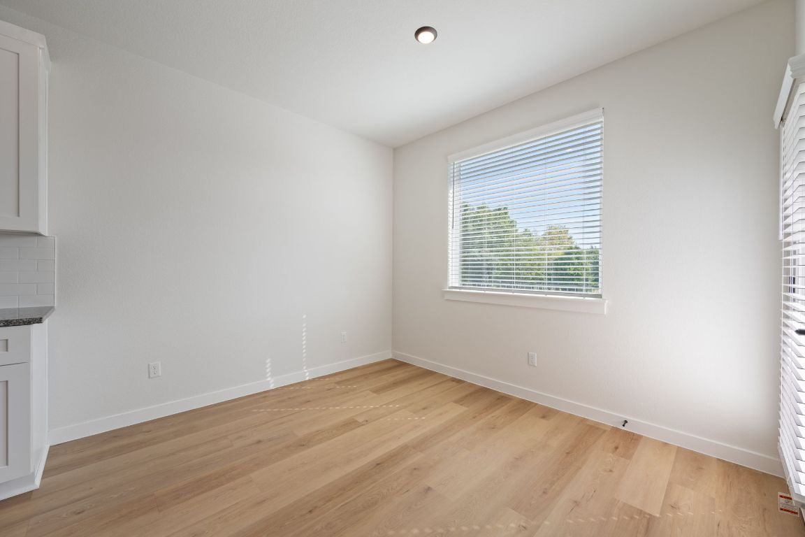 2600 Gattis School Road, Unit 1202 Round Rock, TX 78664 - Photo 9 of 24 Unfurnished dining area featuring light wood-style floors and baseboards