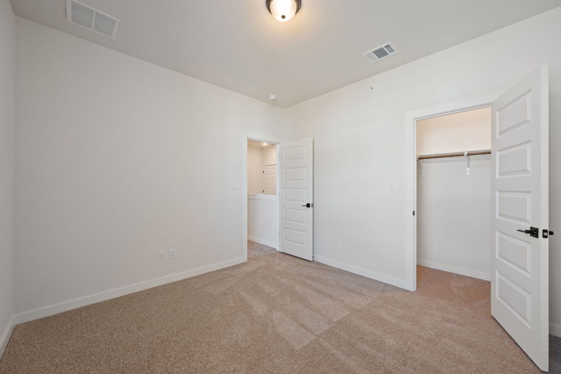 2600 Gattis School Road, Unit 1202 Round Rock, TX 78664 - Photo 16 of 24 Unfurnished bedroom featuring light carpet and a spacious closet