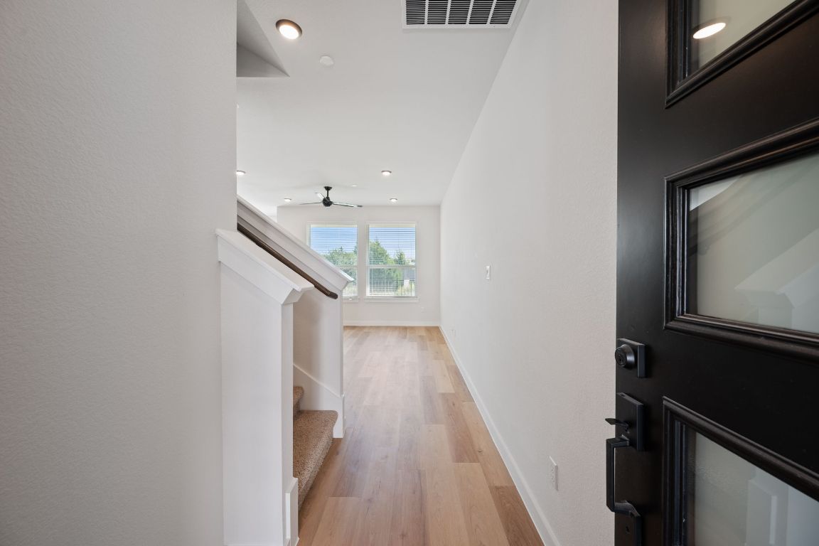 2600 Gattis School Road, Unit 1202 Round Rock, TX 78664 - Photo 2 of 24 Hall featuring light wood-style floors, stairs, and recessed lighting