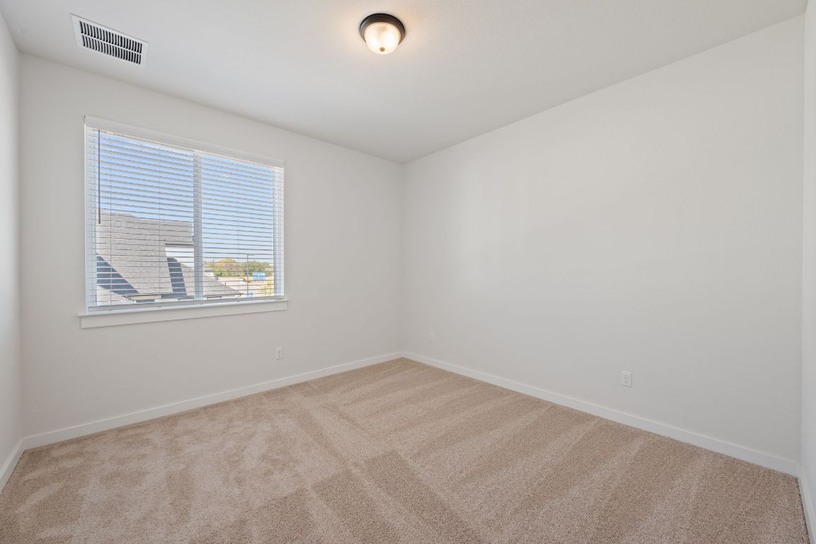 2600 Gattis School Road, Unit 1202 Round Rock, TX 78664 - Photo 18 of 24 Spare room featuring light colored carpet and baseboards