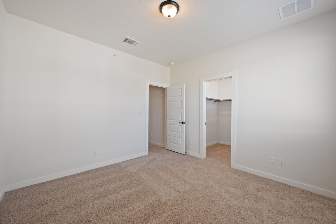 2600 Gattis School Road, Unit 1202 Round Rock, TX 78664 - Photo 19 of 24 Unfurnished bedroom with a spacious closet and light colored carpet