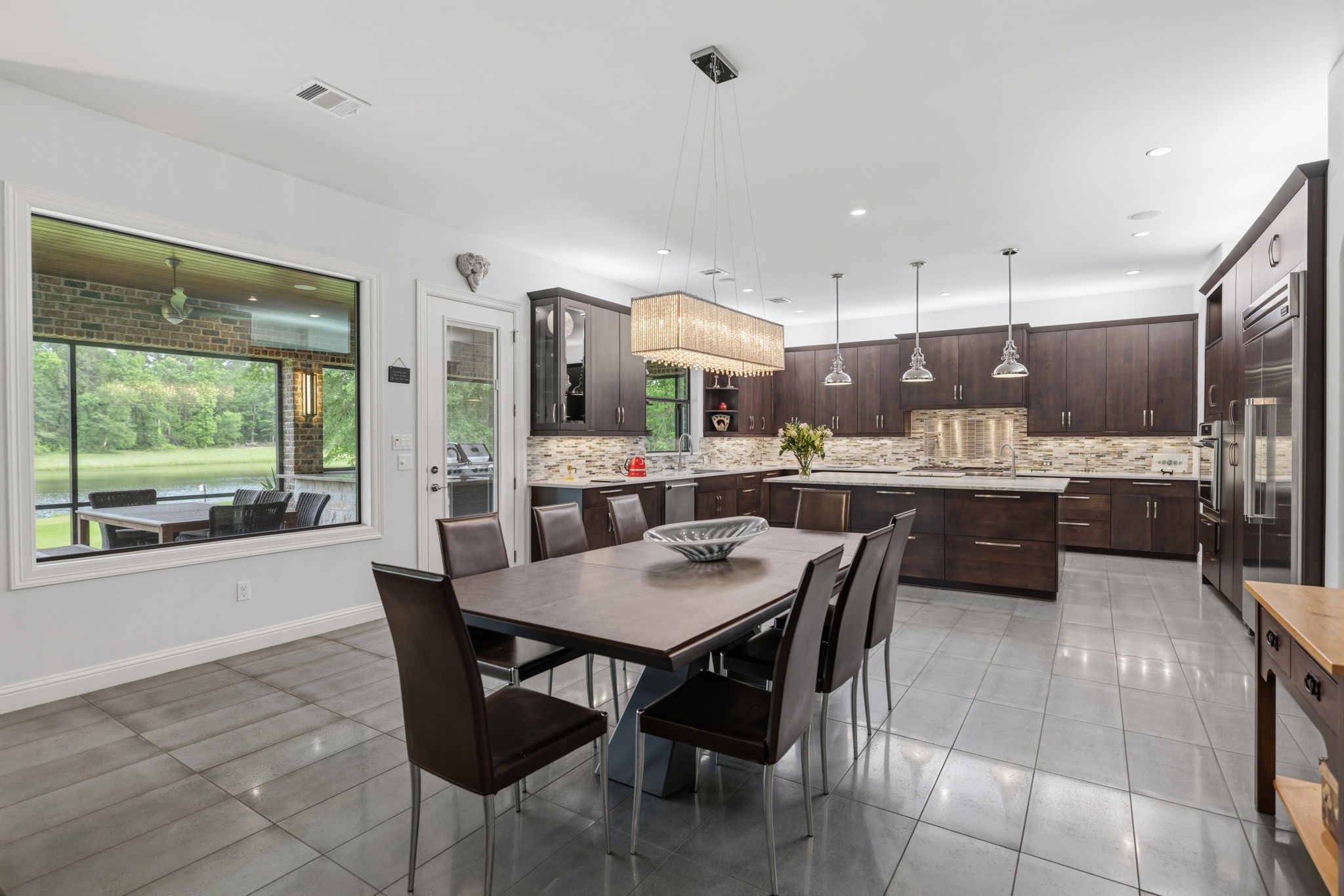 6918 Comanche Bend Montgomery, TX 77316 - Photo 21 of 50 Open concept living at its best, the custom-designed kitchen is perfect for all the cooks in the family, offering beautiful finishes, wonderful workspace, and seamless flow into the main living and entertaining areas. Keep touring, we have a SURPRISE waiting for you!