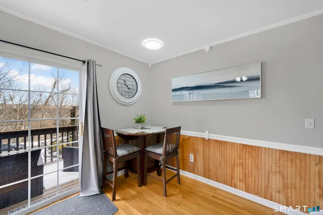 a view of a room with furniture and wooden floor
