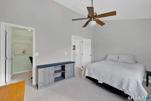 a bathroom with a sink vanity mirror and toilet