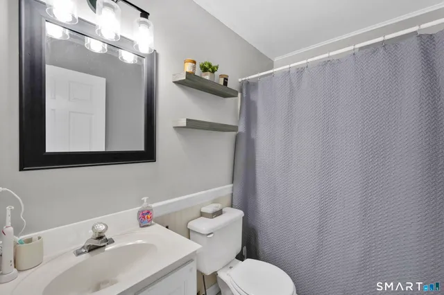 a bedroom with bed and flat screen tv