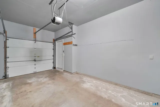 a view of multiple house with garage and yard