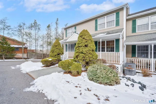 a view of a house with a yard and pathway