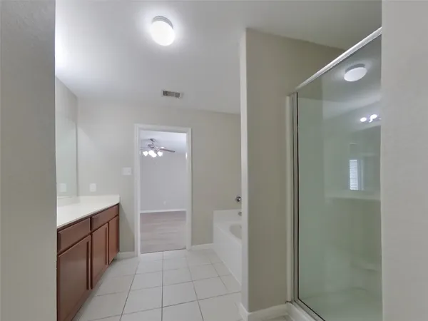 a bathroom with a mirror and a shower