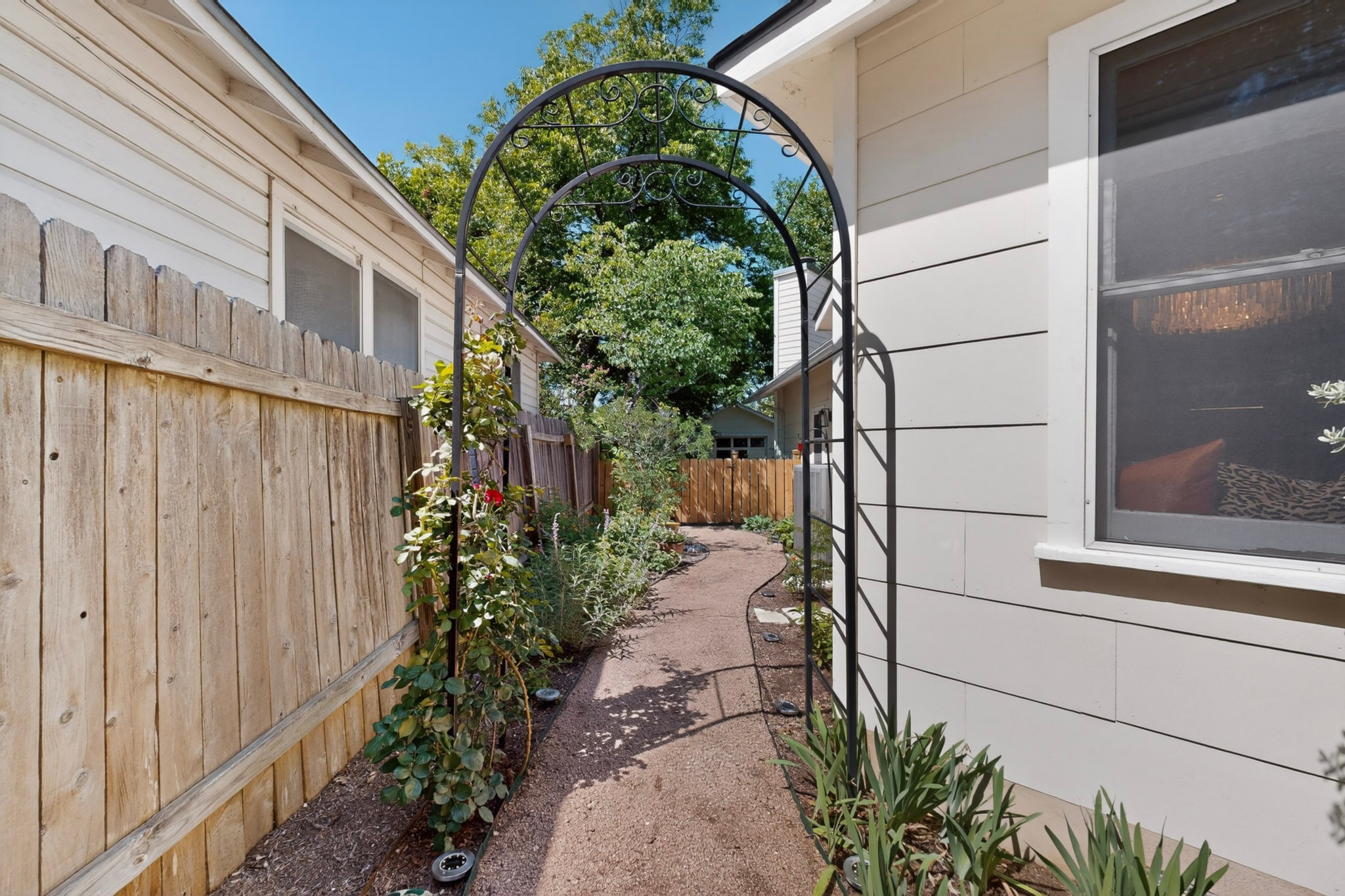 1906 Collier Street Austin, TX 78704 - Photo 27 of 40 A peaceful walkway leads to a lush garden space with climbing rose arches. Here you can plant and cultivate whatever pleases you!