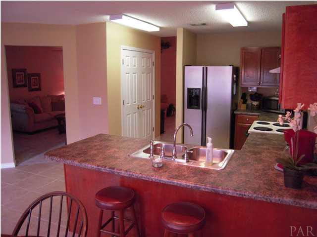 4762 Ribault Lane Milton, FL 32570 - Photo 11 of 24 Kitchen from breakfast nook. Double doors to the left is your large pantry.