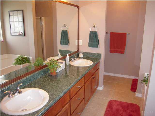 4762 Ribault Lane Milton, FL 32570 - Photo 16 of 24 Master bath w/garden tub to your right, shower & commode straight ahead behind wall. New gorgeous earthtone tile installed Sept. 2008.