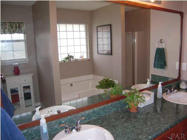 4762 Ribault Lane Milton, FL 32570 - Photo 17 of 24 Master bathroom garden tub with large window, area to left for additional furniture pieces for linens or decor. Seperate shower is far right.