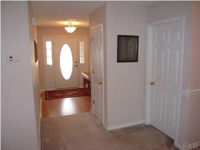 4762 Ribault Lane Milton, FL 32570 - Photo 2 of 24 Additional bedrooms to the left of front door. 1st door to the right is coat closet, 2nd is laundry room.