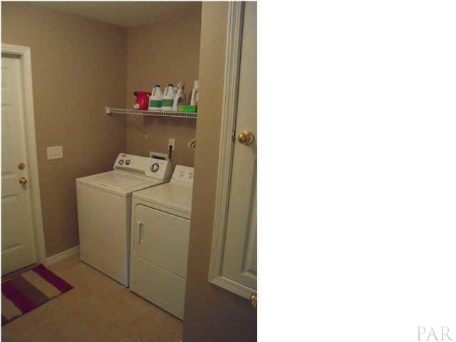 4762 Ribault Lane Milton, FL 32570 - Photo 22 of 24 Laundry room with new tile 09/08. Door to the right is a/c closet. You'll never hear this humming while relaxing in family room.