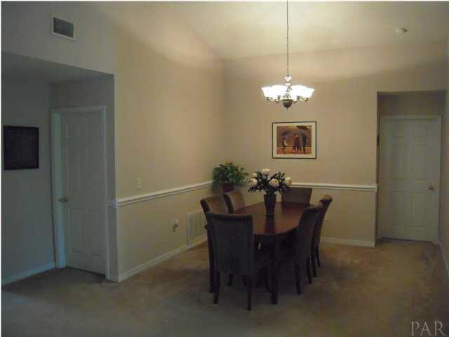 4762 Ribault Lane Milton, FL 32570 - Photo 6 of 24 Shot of dining room from great room. New brushed nickle light fixture. Door to right leads to master suite.