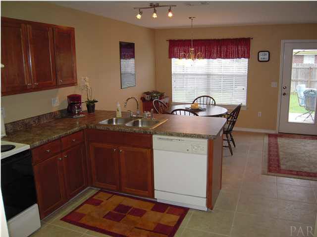4762 Ribault Lane Milton, FL 32570 - Photo 7 of 24 View of kitchen from enterance by dining room. Pantry to your right, den to your far right.