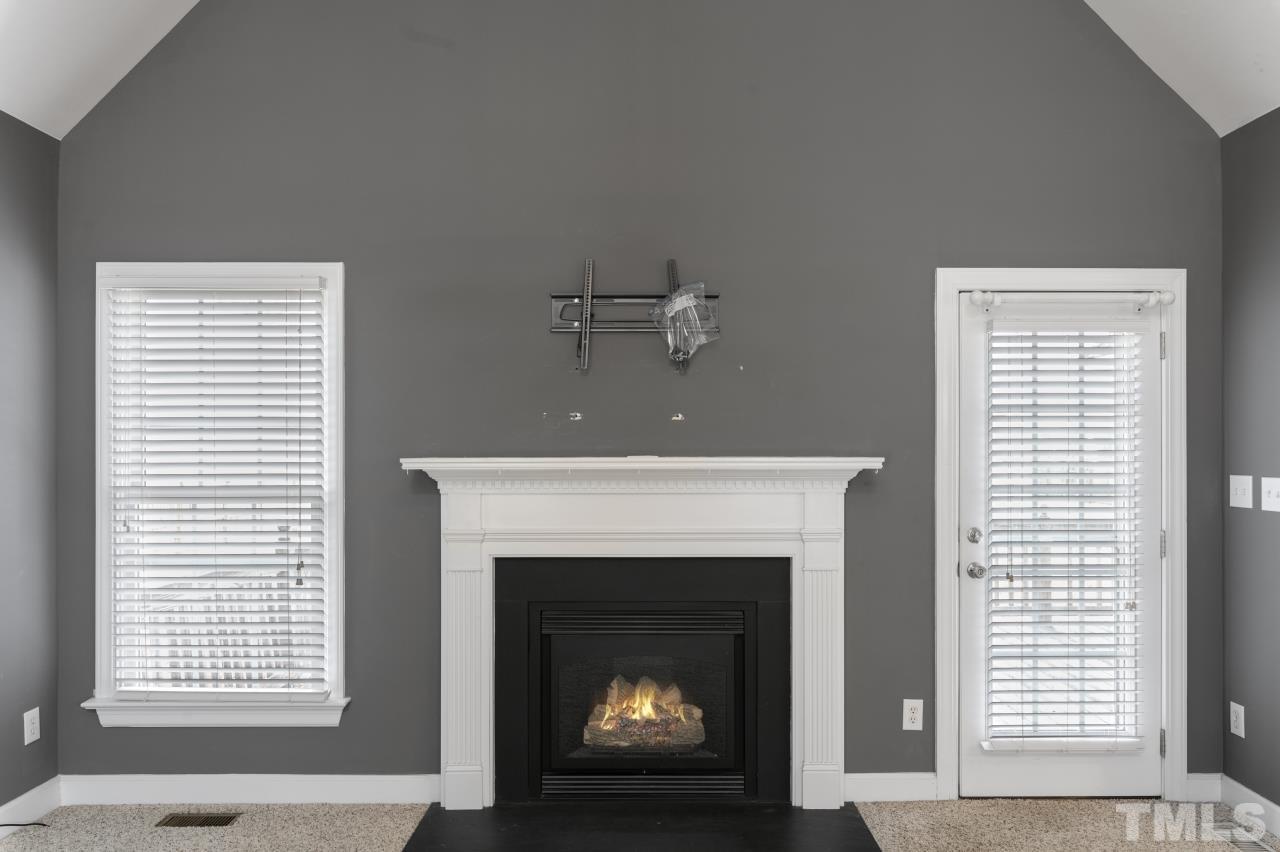 10839 McKenzie Road Bailey, NC 27807 - Photo 14 of 37 a living room with a fireplace and a window