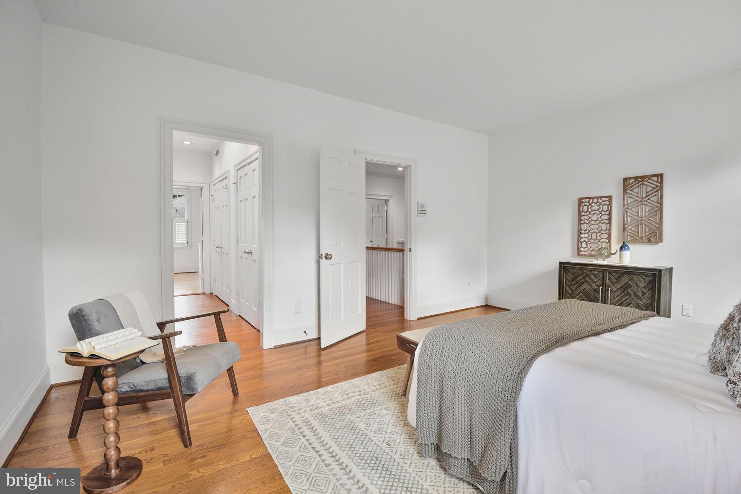 5222 Loughboro Road Northwest Washington, DC 20016 - Photo 25 of 47 a spacious bedroom with a bed and a chair