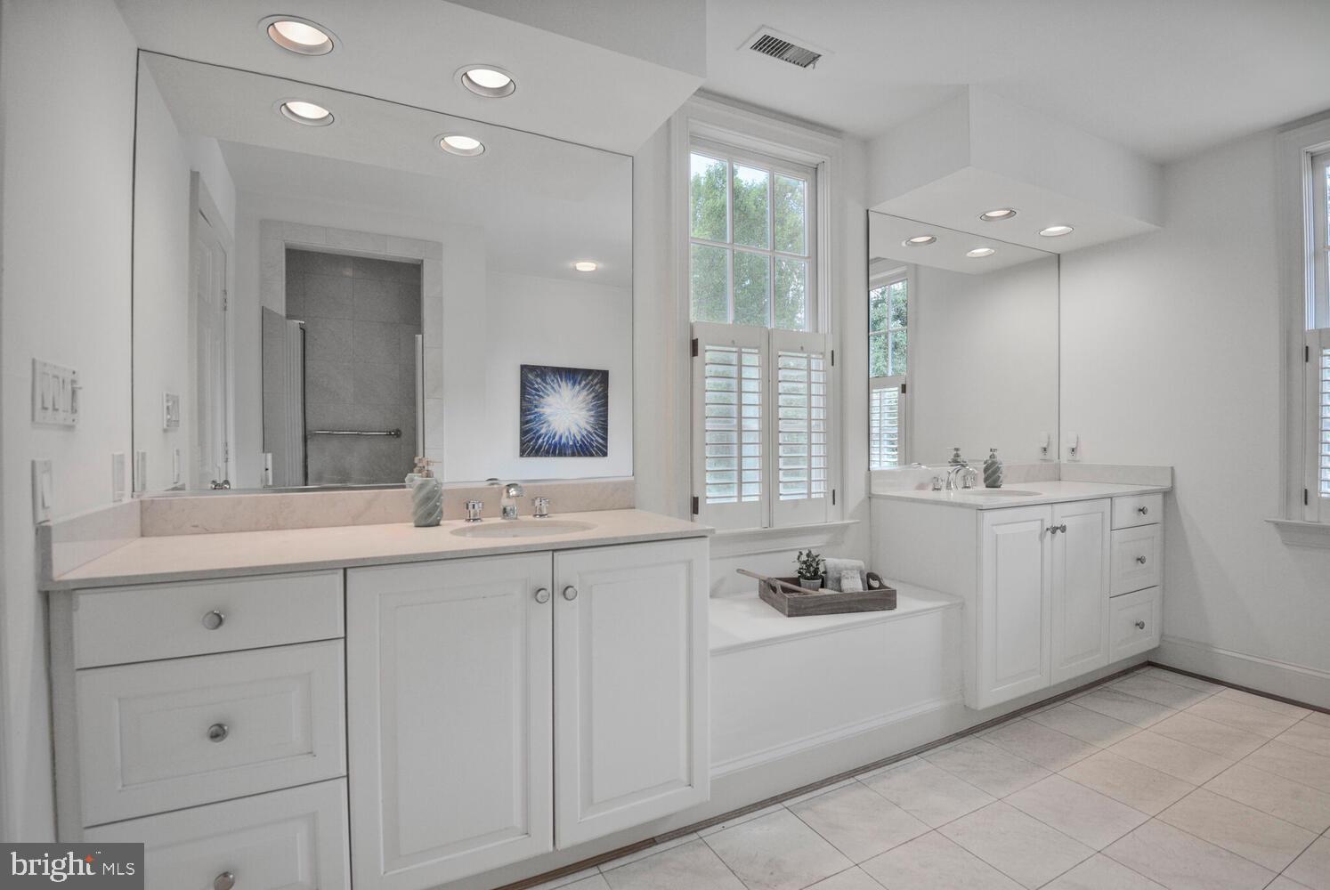 5222 Loughboro Road Northwest Washington, DC 20016 - Photo 27 of 47 a bathroom with a sink double vanity and a mirror