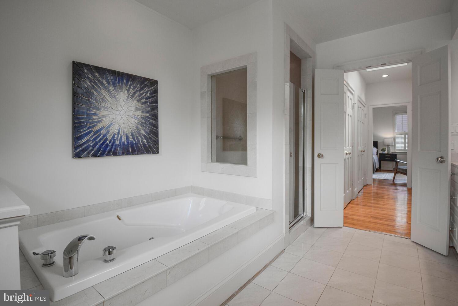 5222 Loughboro Road Northwest Washington, DC 20016 - Photo 28 of 47 a bathroom with a tub and a shower