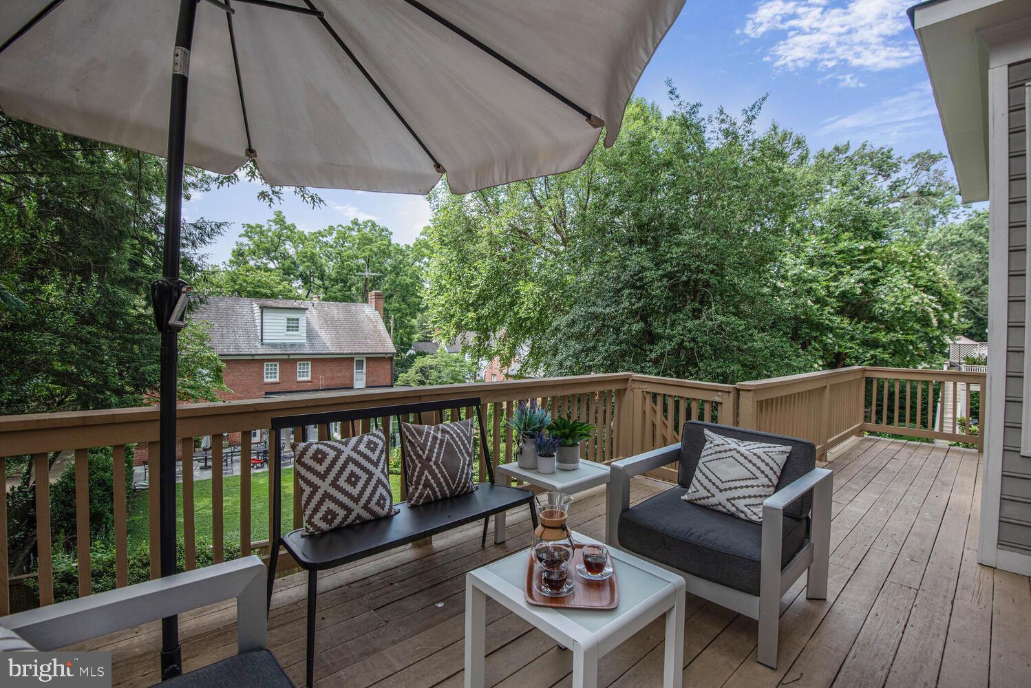 5222 Loughboro Road Northwest Washington, DC 20016 - Photo 32 of 47 a view of a balcony with wooden floor and outdoor seating