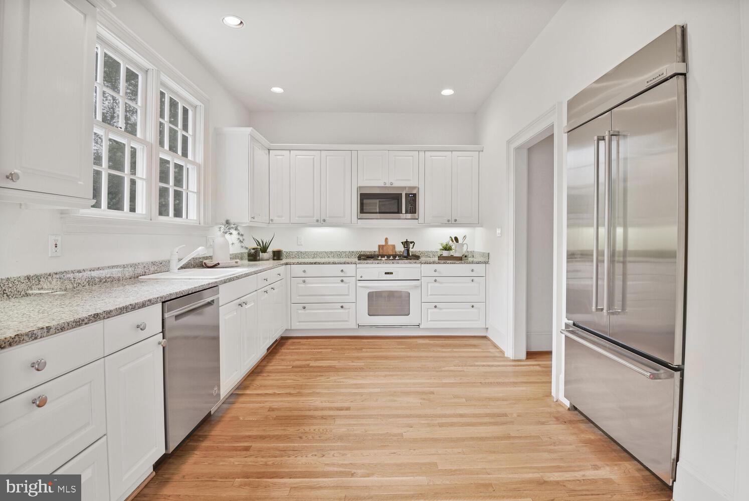 5222 Loughboro Road Northwest Washington, DC 20016 - Photo 9 of 47 a large kitchen with stainless steel appliances granite countertop a stove a sink and a refrigerator