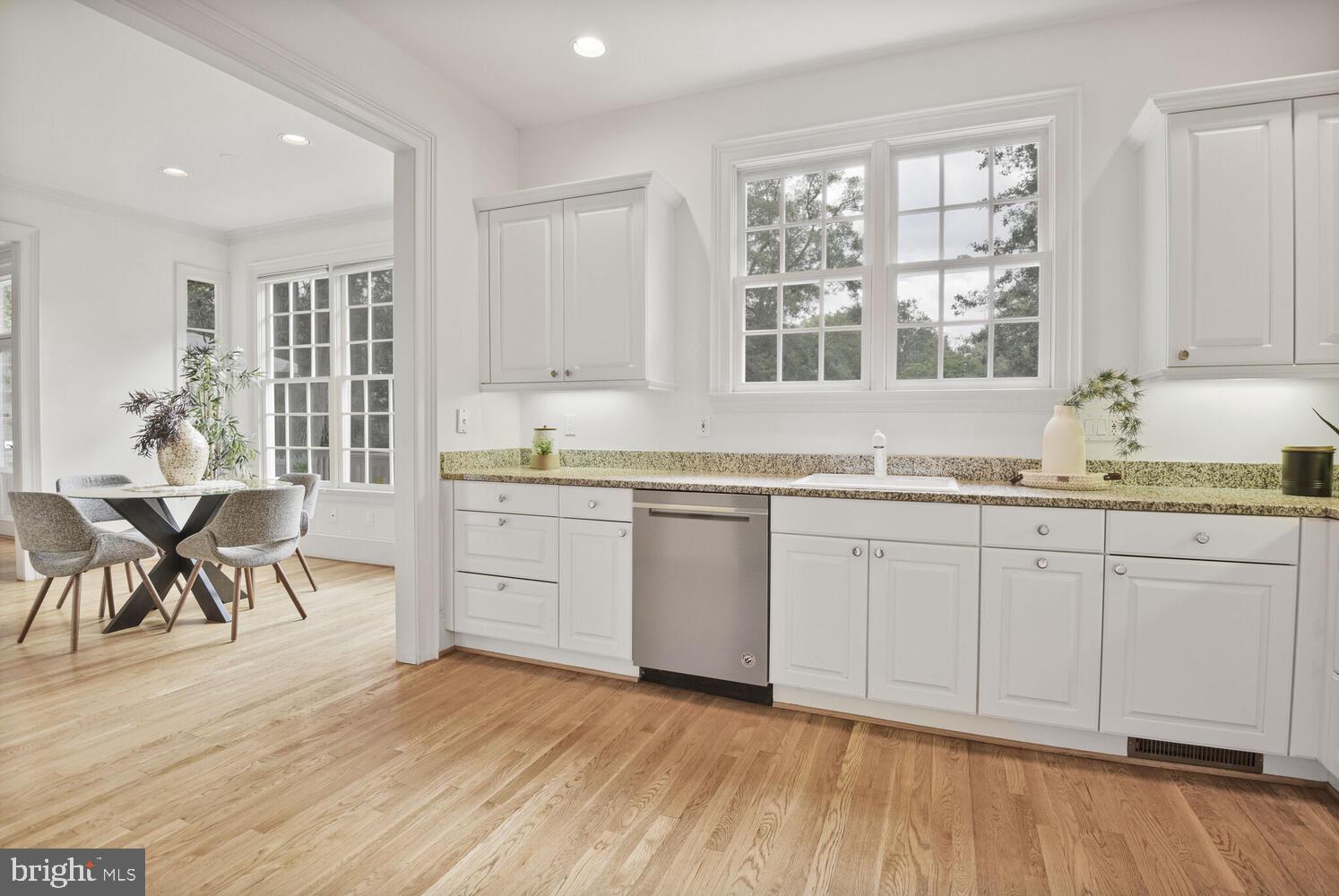 5222 Loughboro Road Northwest Washington, DC 20016 - Photo 10 of 47 a kitchen with granite countertop white cabinets and white appliances