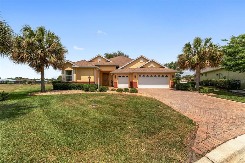 8463 Southwest 84th Loop Ocala, FL 34481 - Photo 1 of 1 a front view of a house with a garden