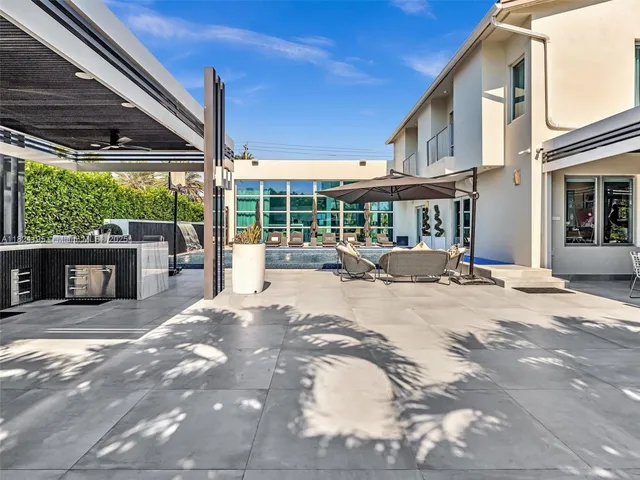 a view of a dining room and livingroom with furniture wooden floor a chandelier